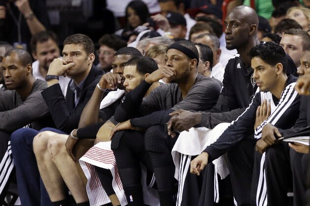 Brooklyn Nets' Paul Pierce, third from right, and Kevin Garnett, second from right, watch from the bench in the second half of Game 1 in an NBA basketball Eastern Conference semifinal playoff series against the Miami Heat, Tuesday, May 6, 2014, in Miami. The Heat defeated the Nets 107-86. (AP Photo/Lynne Sladky)