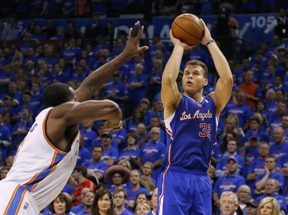 Los Angeles Clippers forward Blake Griffin,right, shoots over Oklahoma City Thunder center Kendrick Perkins, left, in the first quarter of Game 1 of the Western Conference semifinal NBA basketball playoff series in Oklahoma City, Monday, May 5, 2014. (AP Photo/Sue Ogrocki)