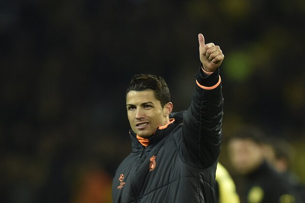 Real's Cristiano Ronaldo waves to his supporters at the end of the the Champions League quarterfinal second leg soccer match between Borussia Dortmund and Real Madrid in the Signal Iduna stadium in Dortmund, Germany, Tuesday, April 8, 2014. (AP Photo/Martin Meissner)
