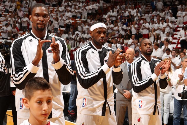 MIAMI, FL - MAY 6: Chris Bosh #1. LeBron James #6, and Dwyane Wade #3 of the Miami Heat stand for the national anthem before Game One of the Eastern Conference Semi-Finals against the Brooklyn Nets during the 2014 NBA Playoffs at American Airlines Arena on May 6, 2014 in Miami, Florida. NOTE TO USER: User expressly acknowledges and agrees that, by downloading and/or using this Photograph, user is consenting to the terms and conditions of the Getty Images License Agreement. Mandatory Copyright Notice: Copyright 2014 NBAE (Photo by Issac Baldizon/NBAE via Getty Images)