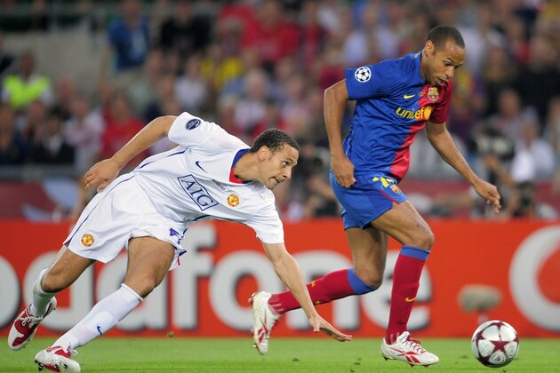 Barcelona's Thierry Henry, right, gets the ball past Manchester United's Rio Ferdinand during the UEFA Champions League final soccer match between Manchester United and Barcelona in Rome, Wednesday May 27, 2009. (AP Photo/Manu Fernandez)