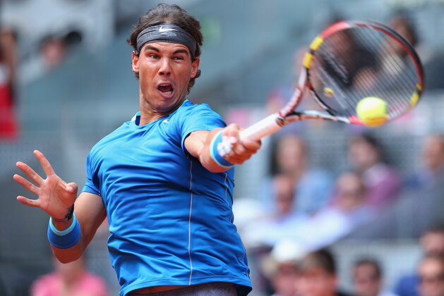 MADRID, SPAIN - MAY 07:  Rafael Nadal of Spain in action against Juan Monaco of Argentina during day five of the Mutua Madrid Open tennis tournament at the Caja Magica on May 7, 2014 in Madrid, Spain.  (Photo by Julian Finney/Getty Images)