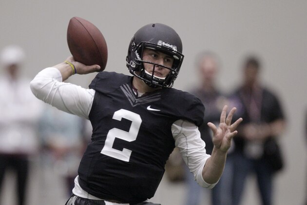 Texas A&M quarterback Johnny Manziel passes the ball during a drill at pro day for NFL football representatives in College Station, Texas, Thursday, March 27, 2014. (AP Photo/Patric Schneider)