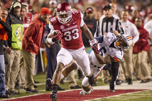 Arkansas running safety Korliss Marshall (33) is pursued by Auburn defensive back Jonathon Mincy (6) during an NCAA college football game in Fayetteville, Ark., Saturday, Nov. 2, 2013. Auburn defeated Arkansas 35-17. (AP Photo/Beth Hall)