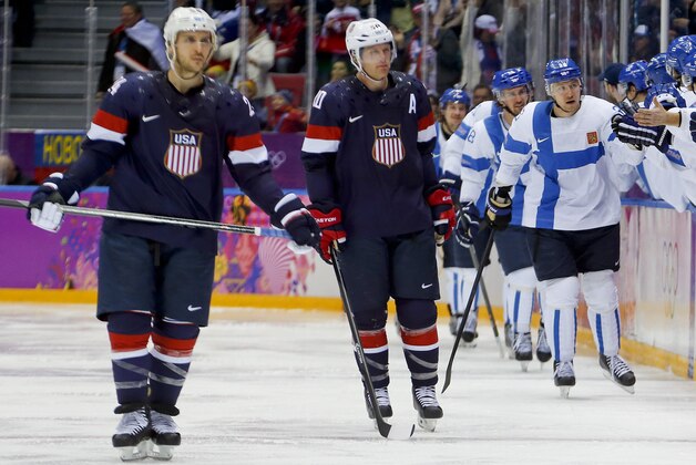 Team Finland celebrates a second period goal against the USA during the men's bronze medal ice hockey game at the 2014 Winter Olympics, Saturday, Feb. 22, 2014, in Sochi, Russia. (AP Photo/Petr David Josek)