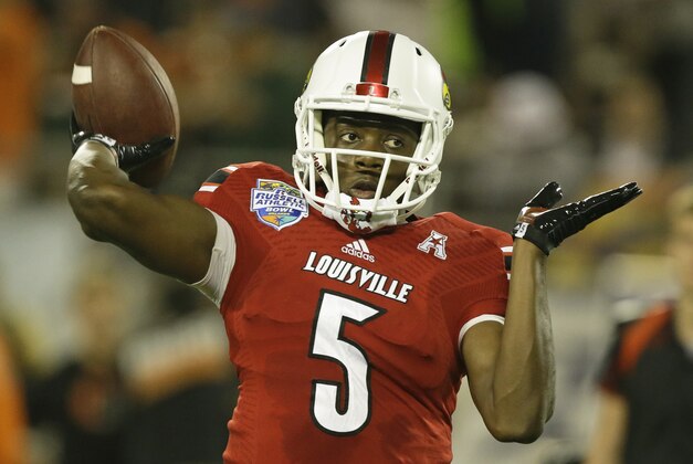 Louisville quarterback Teddy Bridgewater (5) throws a pass warming up for the  Russell Athletic Bowl NCAA college football game against Miami in Orlando, Fla., Saturday, Dec. 28, 2013.(AP Photo/John Raoux)