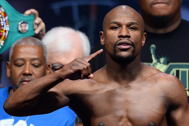 LAS VEGAS, NV - MAY 02:  WBC welterweight champion Floyd Mayweather Jr. poses on the scale during his official weigh-in at the MGM Grand Garden Arena on May 2, 2014 in Las Vegas, Nevada. Mayweather will meet WBA champion Marcos Maidana in a WBC/WBA unification fight in Las Vegas on May 3.  (Photo by Ethan Miller/Getty Images)