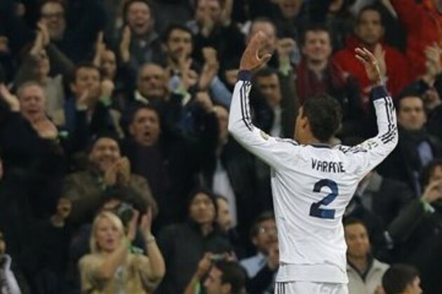 Real Madrid's Raphael Varane from France celebrates his goal during a semifinal, first leg, Copa del Rey soccer match against FC Barcelona at the Santiago Bernabeu stadium in Madrid, Spain, Wednesday, Jan. 30, 2013. (AP Photo/Andres Kudacki)