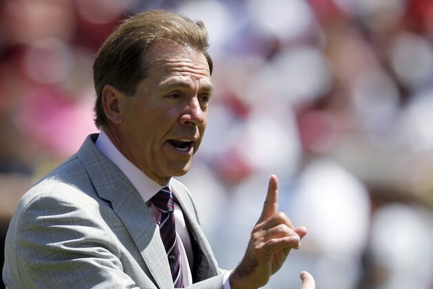 Alabama coach Nick Saban signals a fourth and 1 during Alabama's A-Day NCAA college football spring game Saturday, April 19, 2014, in Tuscaloosa, Ala. (AP Photo/Butch Dill)