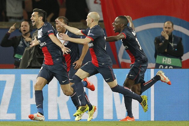 PSG's Javier Pastore, left, celebrates after scoring his sides 3rd goal during the Champions League quarterfinal first leg soccer match between PSG and Chelsea, at the Parc des Princes stadium, in Paris, Wednesday, April 2, 2014. (AP Photo/Christophe Ena)