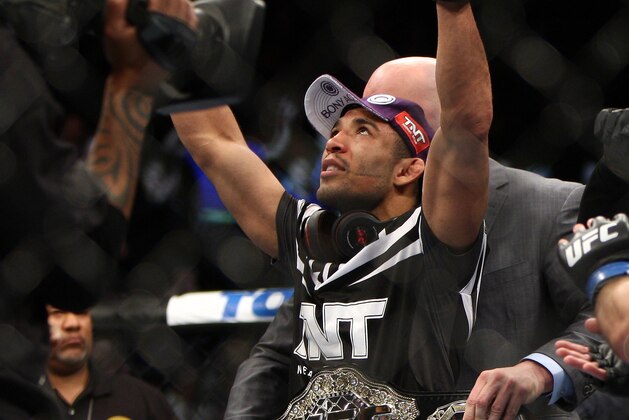 Jose Aldo, left of Brazil celebrates after beating Ricardo Lamas of Chicago, IL in five rounds of the Ultimate Fighting Featherweight Championship Mix Martial Arts bout in Newark, N.J. on Saturday, Feb. 1, 2014. Aldo won by unanimous decision in five rounds. (AP Photo/Tim Larsen)