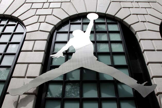 FILE - In this June 27, 2011 file photo, the Nike Air Jordan logo is shown in front of the Niketown store in downtown Portland, Ore. The way Americans are chomping Big Macs, lacing up Air Jordans and gulping peppermint mochas at Starbucks in this abysmal economy, you’d think they’re taking advantage of big holiday discounts. (AP Photo/Rick Bowmer, File)