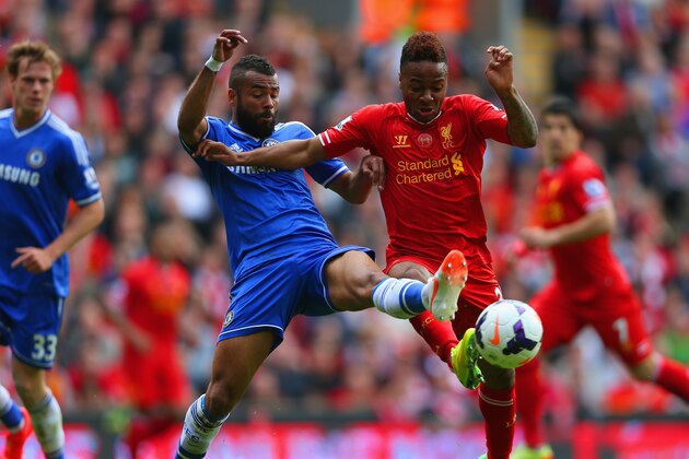 LIVERPOOL, ENGLAND - APRIL 27:  Ashley Cole of Chelsea and Raheem Sterling of Liverpool battle for the ball during the Barclays Premier League match between Liverpool and Chelsea at Anfield on April 27, 2014 in Liverpool, England.  (Photo by Clive Brunskill/Getty Images)