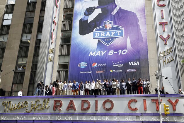 The 2014 NFL draft prospects line up on the awning of Radio City Music Hall for a photograph in New York, Wednesday, May 7, 2014. The draft, which takes place at Radio City Music Hall, will start on Thursday, May 8, 2014. (AP Photo/Seth Wenig)