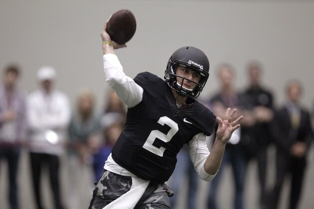 Texas A&M quarterback Johnny Manziel passes the ball during a drill at pro day for NFL football representatives in College Station, Texas, Thursday, March 27, 2014. (AP Photo/Patric Schneider)