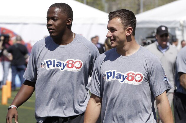 Louisville's Teddy Bridgewater, left, and Texas A&M's Johnny Manziel participate in an NFL football event in New York, Wednesday, May 7, 2014. The event was to promote Play 60, an NFL program which encourages kids to be active for a healthy life. (AP Photo/Seth Wenig)