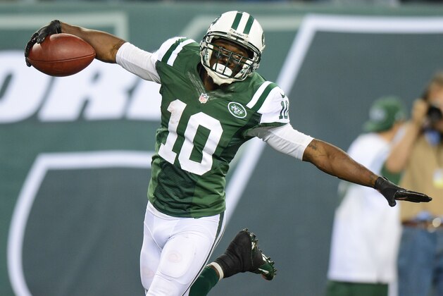 EAST RUTHERFORD, NJ - SEPTEMBER 22: Wide receiver Santonio Holmes #10 of the New York Jets celebrates after his 69 yard touchdown catch in the 2nd half of the Jets 27-20 win over the Buffalo Bills at MetLife Stadium on September 22, 2013 in East Rutherford, New Jersey. (Photo by Ron Antonelli/Getty Images)