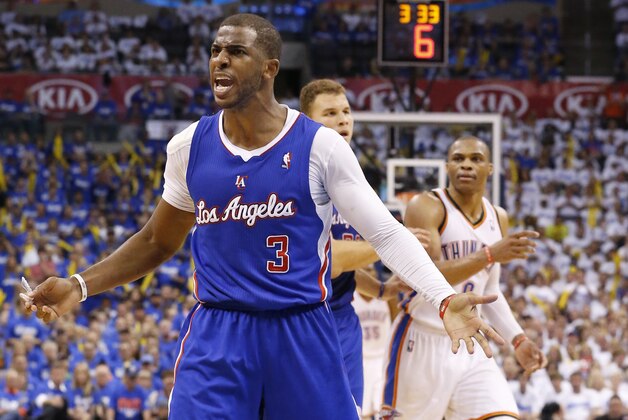 Los Angeles Clippers guard Chris Paul (3) complains to an official in front of Oklahoma City Thunder guard Russell Westbrook (0) in the third quarter of Game 2 of the Western Conference semifinal NBA basketball playoff series in Oklahoma City, Wednesday, May 7, 2014. Oklahoma City won 112-101. (AP Photo/Sue Ogrocki)