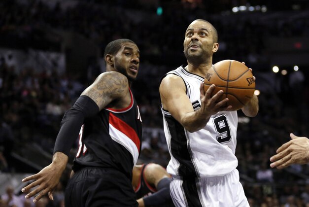 May 6, 2014; San Antonio, TX, USA; San Antonio Spurs guard Tony Parker (9) drives to the basket past Portland Trail Blazers forward LaMarcus Aldridge (12) in game one of the second round of the 2014 NBA Playoffs at AT&T Center. Mandatory Credit: Soobum Im-USA TODAY Sports