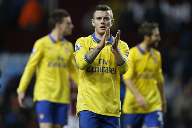 Arsenal's  Jack Wilshere, applauds the fans at the end of the English Premier League soccer match between Aston Villa and Arsenal at Villa Park stadium in Birmingham, England, Monday, Jan. 13, 2014. (AP Photo/Kirsty Wigglesworth)