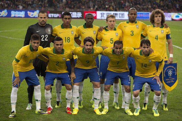 FILE - In this Oct. 15, 2013 file photo, Brazil soccer team poses prior to the start their  international friendly soccer match against Zambia at the Bird's Nest national stadium in Beijing, China. Background from left: Diego Cavalier, Paulinho, Ramires, Lucas, Anderson Dede, and David Luiz. Foreground from left: Neymar, Dani Alves, Alexandre Pato, Lucas Moura and Maxwell.  (AP Photo/Ng Han Guan, File)