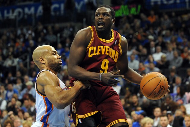 Feb 26, 2014; Oklahoma City, OK, USA; Cleveland Cavaliers small forward Luol Deng (9) handles the ball against Oklahoma City Thunder point guard Derek Fisher (6) during the second quarter at Chesapeake Energy Arena. Mandatory Credit: Mark D. Smith-USA TODAY Sports