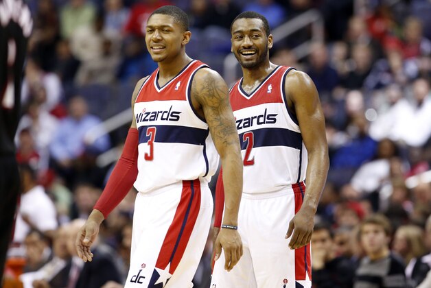 Washington Wizards guard Bradley Beal (3) and Washington Wizards guard John Wall (2) smile in the second half of an NBA basketball game against the Portland Trail Blazers, Monday, Feb. 3, 2014, in Washington. The Wizards won 100-90. (AP Photo/Alex Brandon)