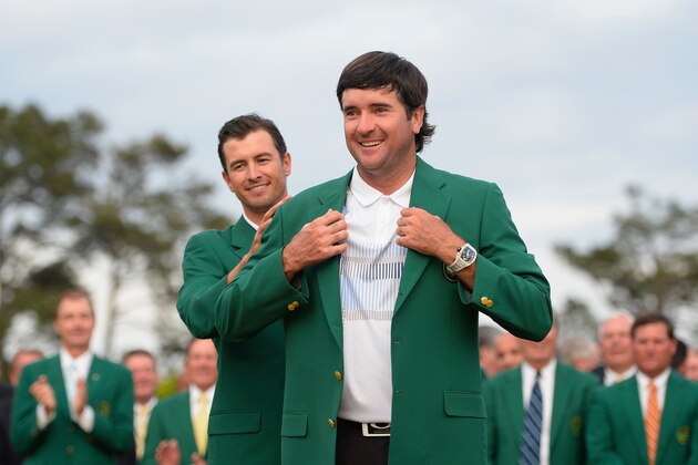AUGUSTA, GA - APRIL 13:  Adam Scott of Australia presents Bubba Watson of the United States with the green jacket after Watson won the 2014 Masters Tournament by a three-stroke margin at Augusta National Golf Club on April 13, 2014 in Augusta, Georgia.  (Photo by Harry How/Getty Images)
