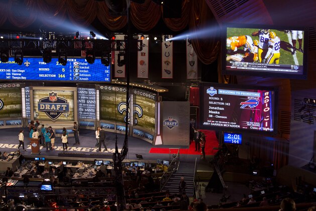 Large television monitors display information above participants of the NFL Draft, Saturday, April 27, 2013 at Radio City Music Hall in New York. (AP Photo/Craig Ruttle)