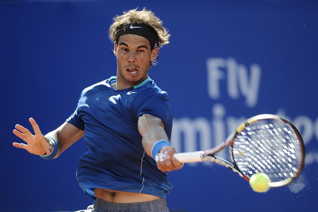 Rafael Nadal returns the ball to Nicolas Almagro during the Barcelona open tennis in Barcelona, Spain, Friday, April 25, 2014. (AP Photo/Manu Fernandez)