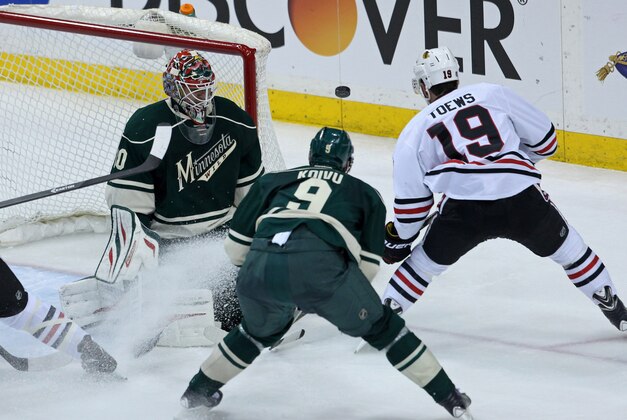 May 6, 2014; Saint Paul, MN, USA; Minnesota Wild goalie Ilya Bryzgalov (30) makes a save on Chicago Blackhawks forward Jonathan Toews (19) during the third period in game three of the second round of the 2014 Stanley Cup Playoffs at Xcel Energy Center. The Wild defeated the Blackhawks 4-0. Mandatory Credit: Brace Hemmelgarn-USA TODAY Sports