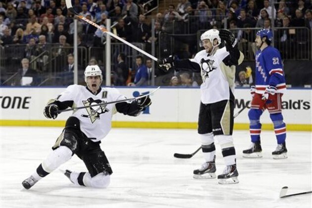 Pittsburgh Penguins' Evgeni Malkin (71), of Russia, celebrates a goal as Chris Kunitz and New York Rangers' Brian Boyle, right, skate near during the first period of a second-round NHL Stanley Cup hockey playoff series Wednesday, May 7, 2014, in New York. (AP Photo/Frank Franklin II)