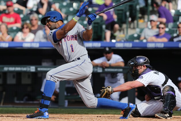 New York Mets' Chris Young, left, strikes out swinging at a pitch as Colorado Rockies catcher Micahel McKenry fields the ball in the ninth inning of the Mets' 5-1 victory in a baseball game in Denver on Sunday, May 4, 2014. (AP Photo/David Zalubowski)