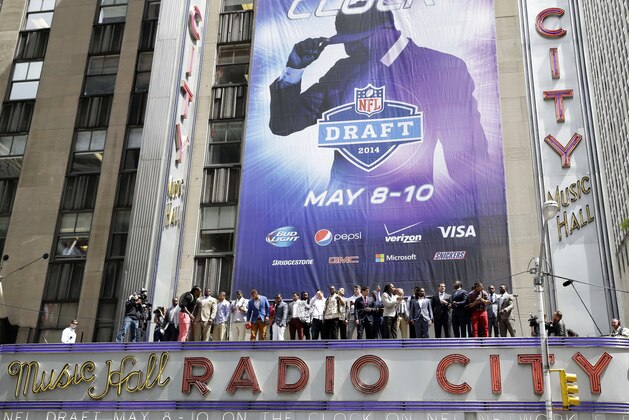 The 2014 NFL draft prospects line up on the awning of Radio City Music Hall for a photograph in New York, Wednesday, May 7, 2014. The draft, which takes place at Radio City Music Hall, will start on Thursday, May 8, 2014. (AP Photo/Seth Wenig)