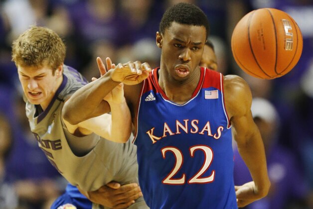 Kansas guard Andrew Wiggins (22) and Kansas State guard Will Spradling, left, chase the ball during the second half of an NCAA college basketball game in Manhattan, Kan., Monday, Feb. 10, 2014. Kansas State defeated Kansas 85-82 in overtime. (AP Photo/Orlin Wagner)