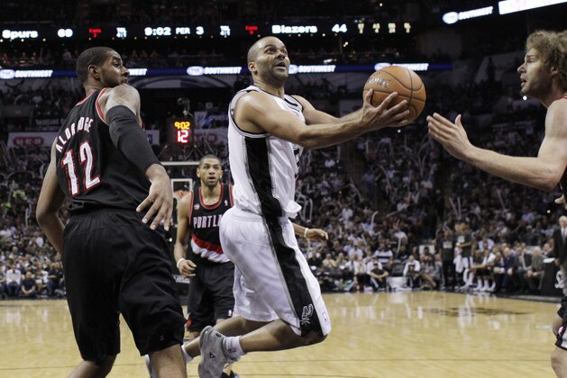 San Antonio Spurs' Tony Parker (9), of France, drives between Portland Trail Blazers' LaMarcus Aldridge (12) and Robin Lopez (42)during the second half of Game 1 of a Western Conference semifinal NBA basketball playoff series, Tuesday, May 6, 2014, in San Antonio.  (AP Photo/)