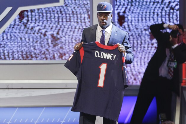 South Carolina defensive end Jadeveon Clowney holds up a jersey for the Houston Texans after being chosen as the first pick in the first round of the 2014 NFL Draft, Thursday, May 8, 2014, in New York. (AP Photo/Frank Franklin II)