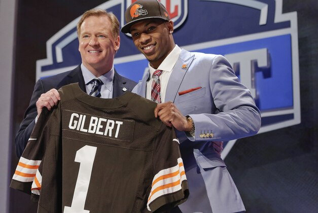 Oklahoma State cornerback Justin Gilbert, right, poses with NFL commissioner Roger Goodell after being selected by the Cleveland Browns as the eighth pick in the first round of the 2014 NFL Draft, Thursday, May 8, 2014, in New York. (AP Photo/Craig Ruttle)