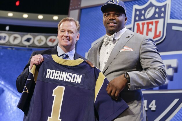 Auburn tackle Greg Robinson, right, poses with NFL commissioner Roger Goodell after being chosen by the St. Louis Rams as the second pick in the first round of the 2014 NFL Draft, Thursday, May 8, 2014, in New York. (AP Photo/Craig Ruttle)