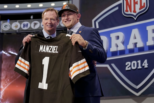 Texas A&M quarterback Johnny Manziel poses with NFL commissioner Roger Goodell after being selected by the Cleveland Browns as the 22nd pick in the first round of the 2014 NFL Draft, Thursday, May 8, 2014, in New York. (AP Photo/Craig Ruttle)