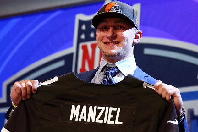 NEW YORK, NY - MAY 08:  Johnny Manziel of the Texas A&M Aggies poses with a jersey after he was picked #22 overall by the Cleveland Browns during the first round of the 2014 NFL Draft at Radio City Music Hall on May 8, 2014 in New York City.  (Photo by Elsa/Getty Images)