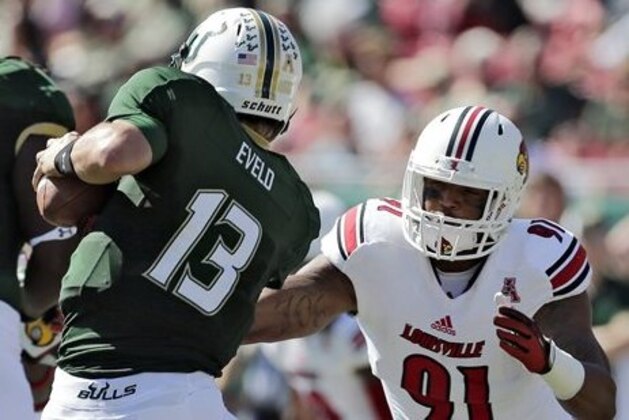 FILE - In this Oct. 26, 2013, file photo, Louisville defensive end Marcus Smith (91) sacks South Florida quarterback Bobby Eveld (13) during the first quarter of an NCAA college football game in Tampa, Fla. Smith was selected in the first round, 26th overall, by the Philadelphia Eagles in the NFL draft on Thursday, May 8, 2014.  (AP Photo/Chris O'Meara, File)