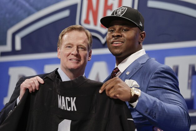 Buffalo linebacker Khalil Mack, right, poses for photos with NFL commissioner Roger Goodell after being selected by the Oakland Raiders as the fifth pick in the first round of the 2014 NFL Draft, Thursday, May 8, 2014, in New York. (AP Photo/Craig Ruttle)