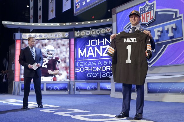 Texas A&M quarterback Johnny Manziel poses for photos after being selected by the Cleveland Browns as the 22nd pick in the first round of the 2014 NFL Draft, Thursday, May 8, 2014, in New York. (AP Photo/Craig Ruttle) Texas A&M quarterback Johnny Manziel poses for photos after being selected by the Cleveland Browns as the 22nd pick in the first round of the 2014 NFL Draft, Thursday, May 8, 2014, in New York. (AP Photo/Craig Ruttle)