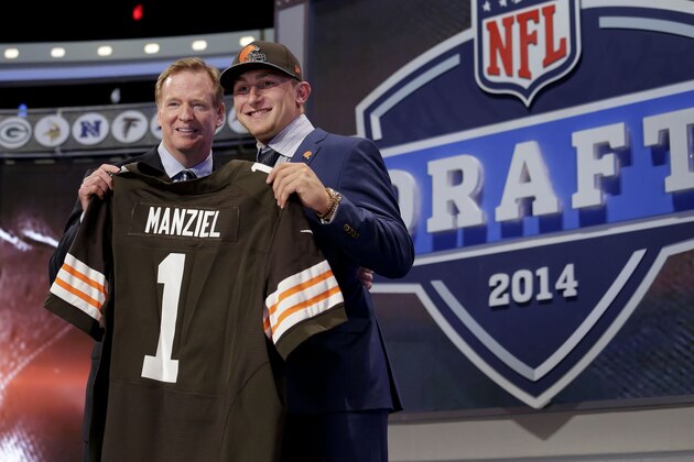 Texas A&M quarterback Johnny Manziel poses with NFL commissioner Roger Goodell after being selected by the Cleveland Browns as the 22nd pick in the first round of the 2014 NFL Draft, Thursday, May 8, 2014, in New York. (AP Photo/Craig Ruttle)