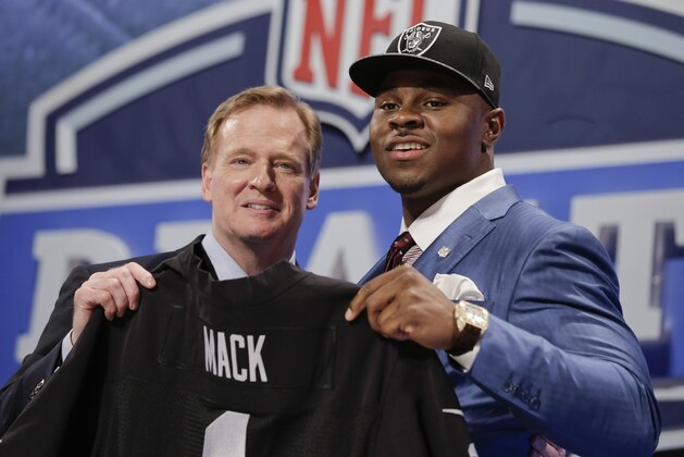 Buffalo linebacker Khalil Mack, right, poses for photos with NFL commissioner Roger Goodell after being selected by the Oakland Raiders as the fifth pick in the first round of the 2014 NFL Draft, Thursday, May 8, 2014, in New York. (AP Photo/Craig Ruttle)