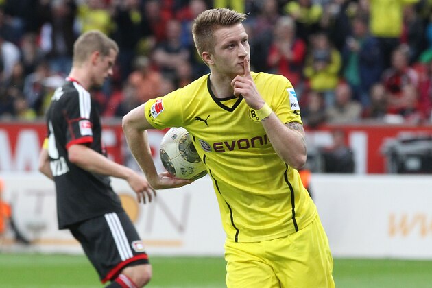 Dortmund's Marco Reus celebrates his side's equalizing goal during a German Bundesliga soccer match between Bayer 04 Leverkusen and Borussia Dortmund in Leverkusen, Germany, Saturday, April 26, 2014. (AP Photo/Michael Probst)
