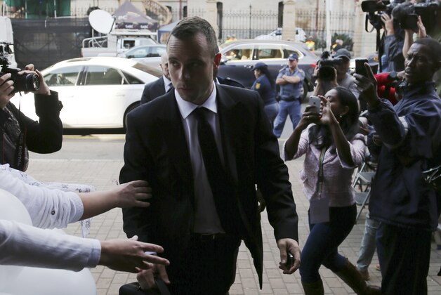 Oscar Pistorius is greetted by fans upon his arrival at the high court in Pretoria, South Africa, Friday, May 9, 2014. Pistorius is charged with murder for the shooting death of his girlfriend, Reeva Steenkamp, on Valentines Day in 2013. (AP Photo/Themba Hadebe)