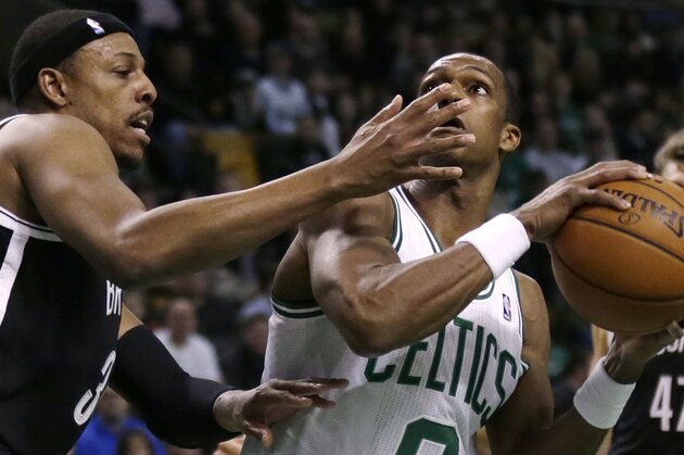 Brooklyn Nets forward Paul Pierce, left, defends Boston Celtics guard Rajon Rondo on a drive to the basket during the first quarter of an NBA basketball game, Friday, March 7, 2014, in Boston. (AP Photo/Charles Krupa)