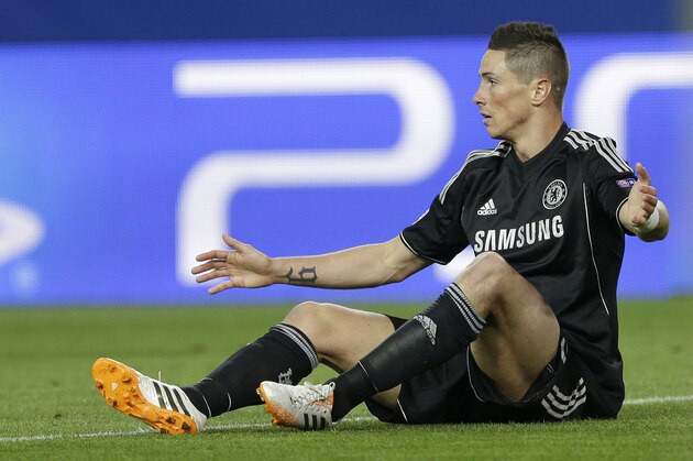 Chelsea's Fernando Torres gestures with his hands as he sits on the ground during the Champions League semifinal first leg soccer match between Atletico Madrid and Chelsea at the Vicente Calderon stadium in Madrid, Spain, Tuesday, April 22, 2014 .(AP Photo/Paul White)